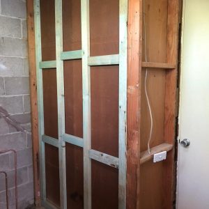 remove existing bathroom back to block and stud walls